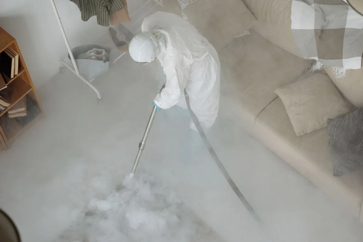 Biohazard cleanup technician in protective equipment, Belterra, TX